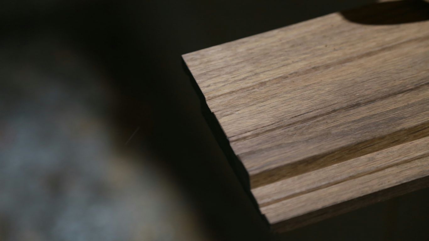 a close up of a watch on a wooden surface