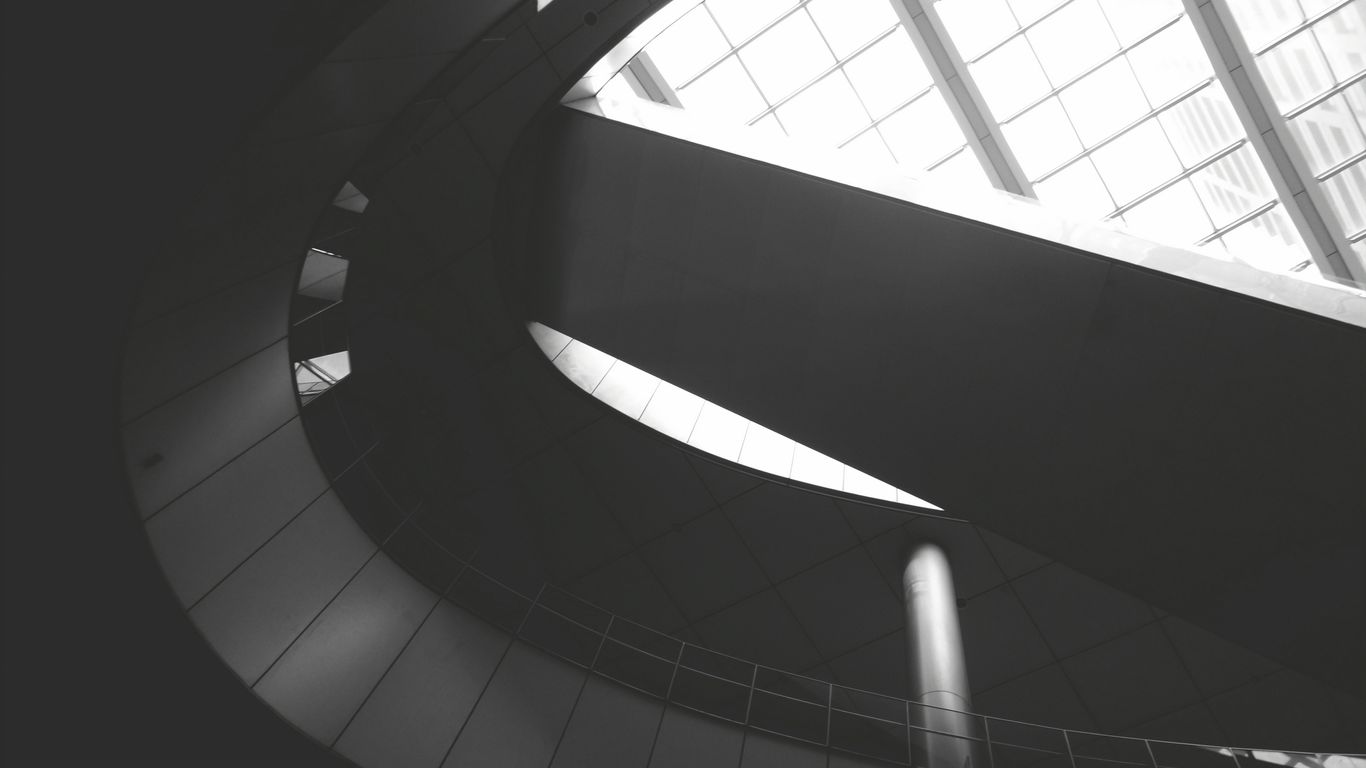 a black and white photo of a spiral staircase