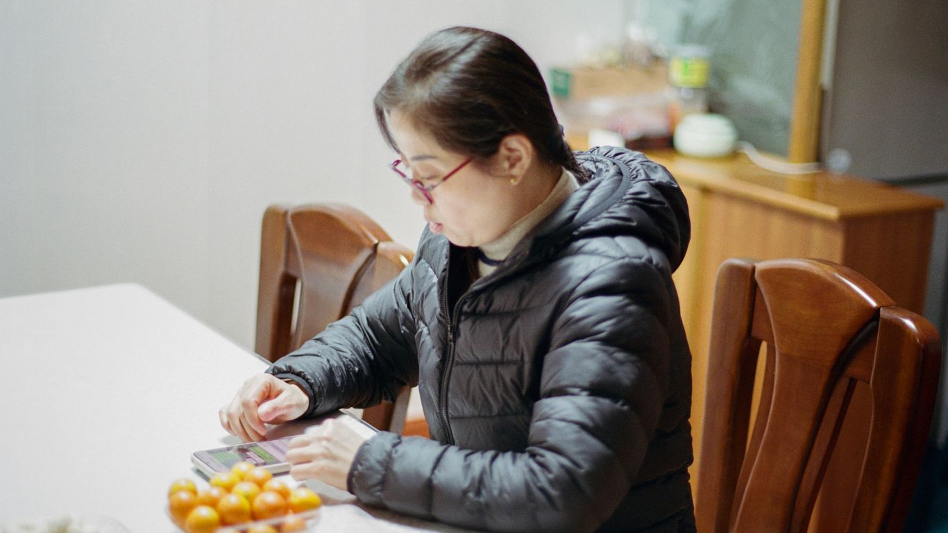 A woman sitting at a table with a plate of food