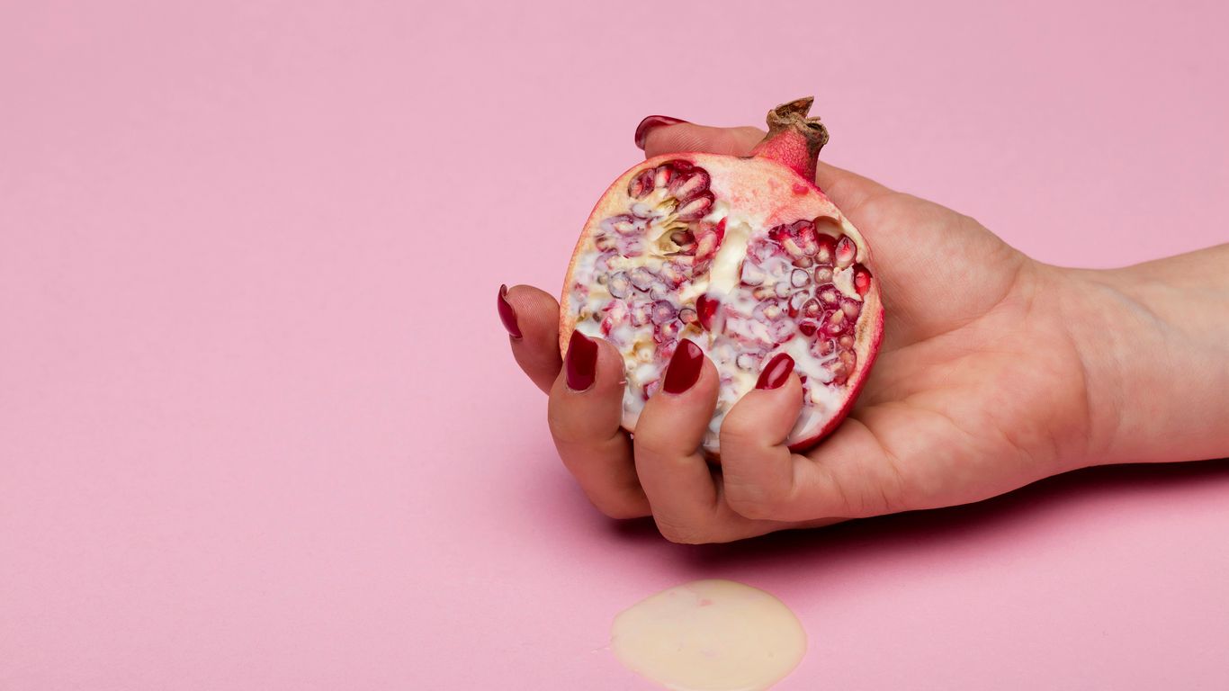 person holding red and white fruit