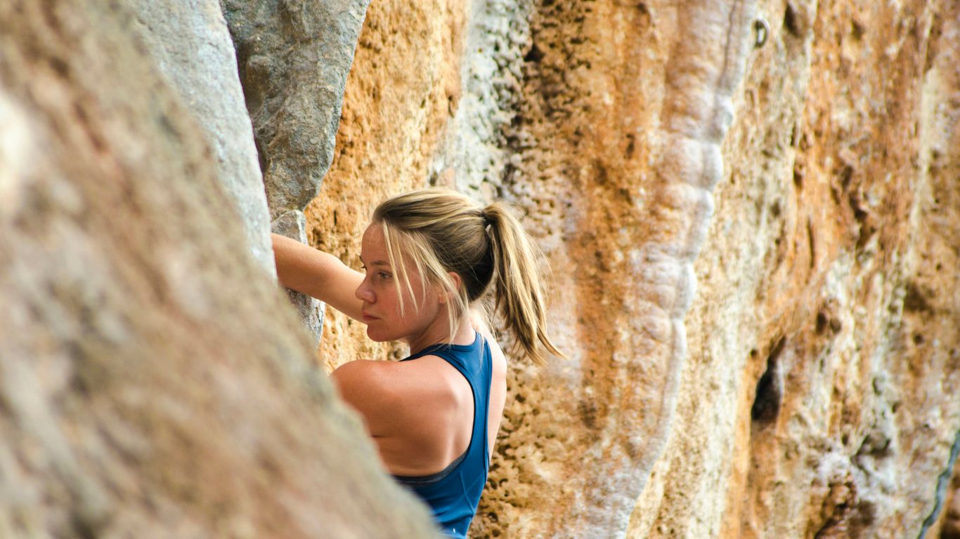 woman climbing mountain