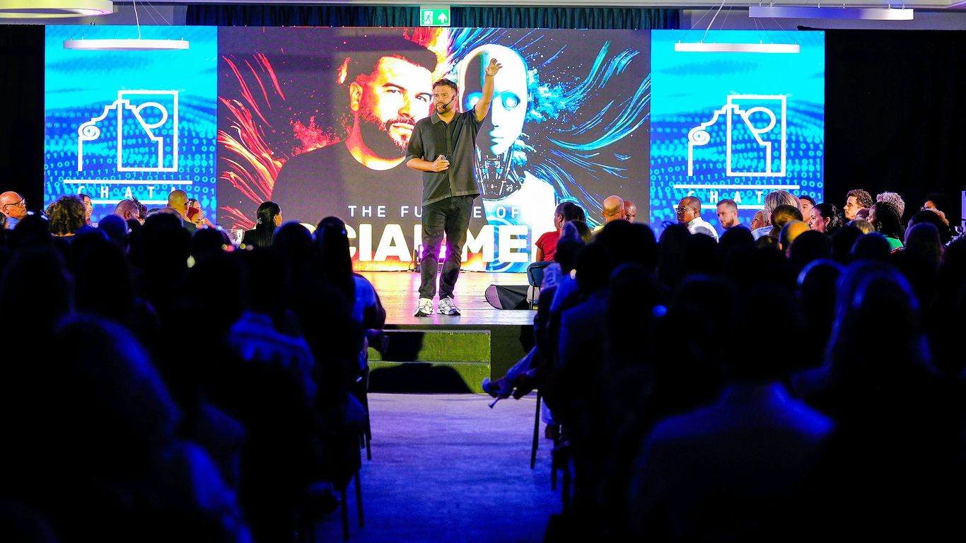 Speaker presenting on stage to an audience