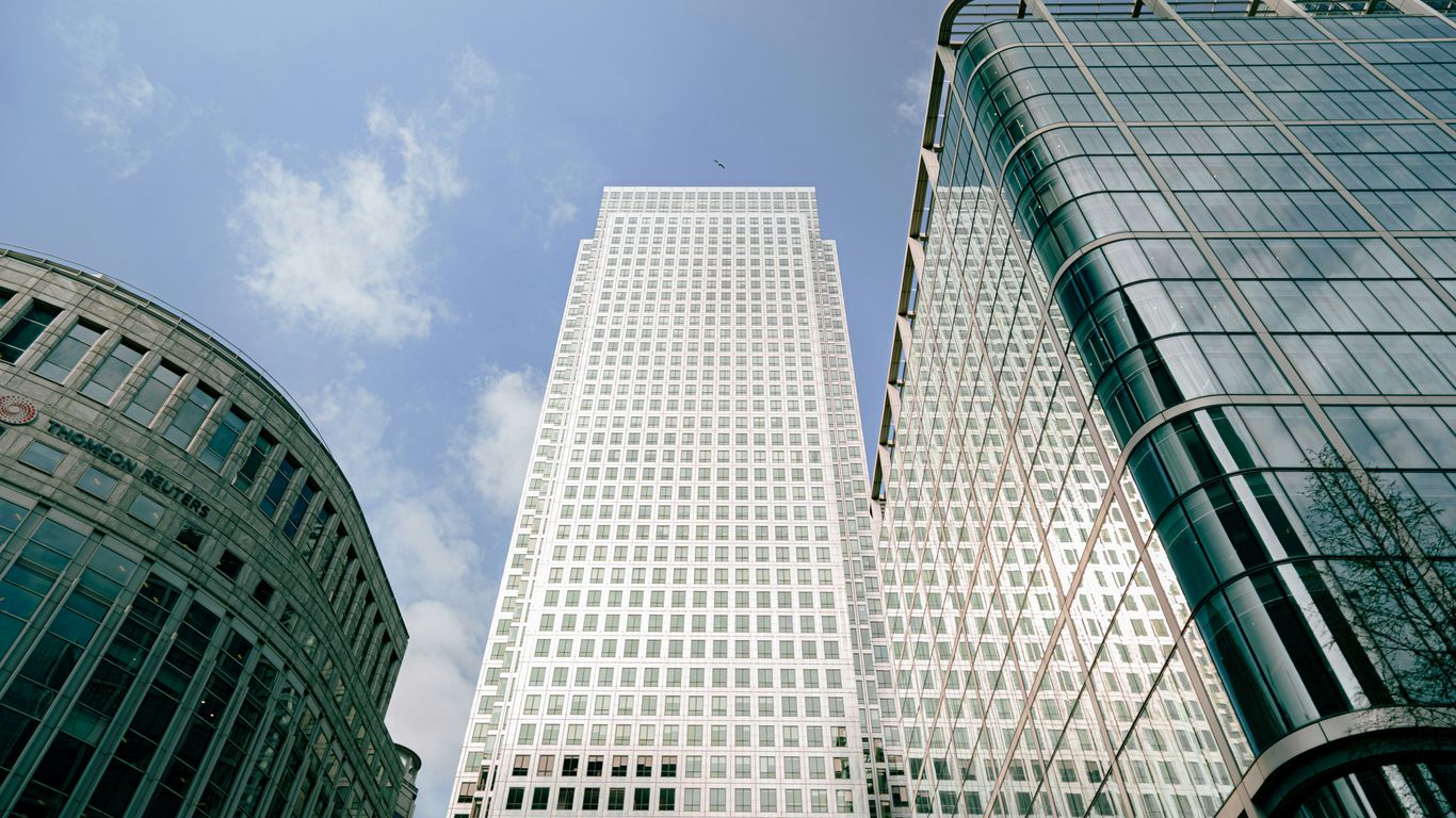 a couple of tall buildings sitting next to each other