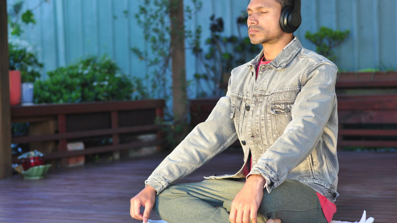 a man sitting on a table wearing headphones