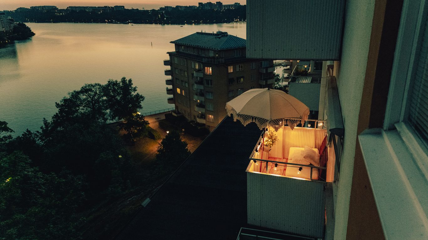 a building with a body of water in the background