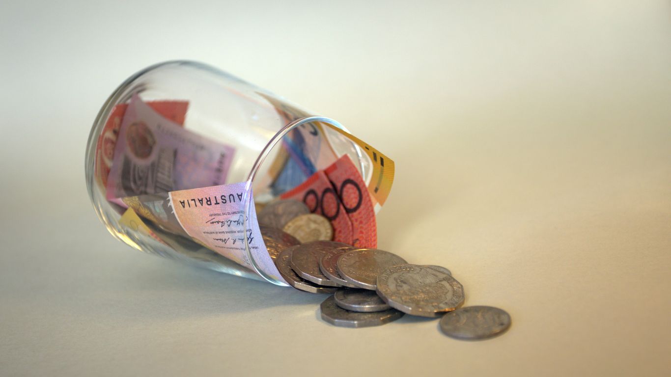 coins and coins in clear glass jar