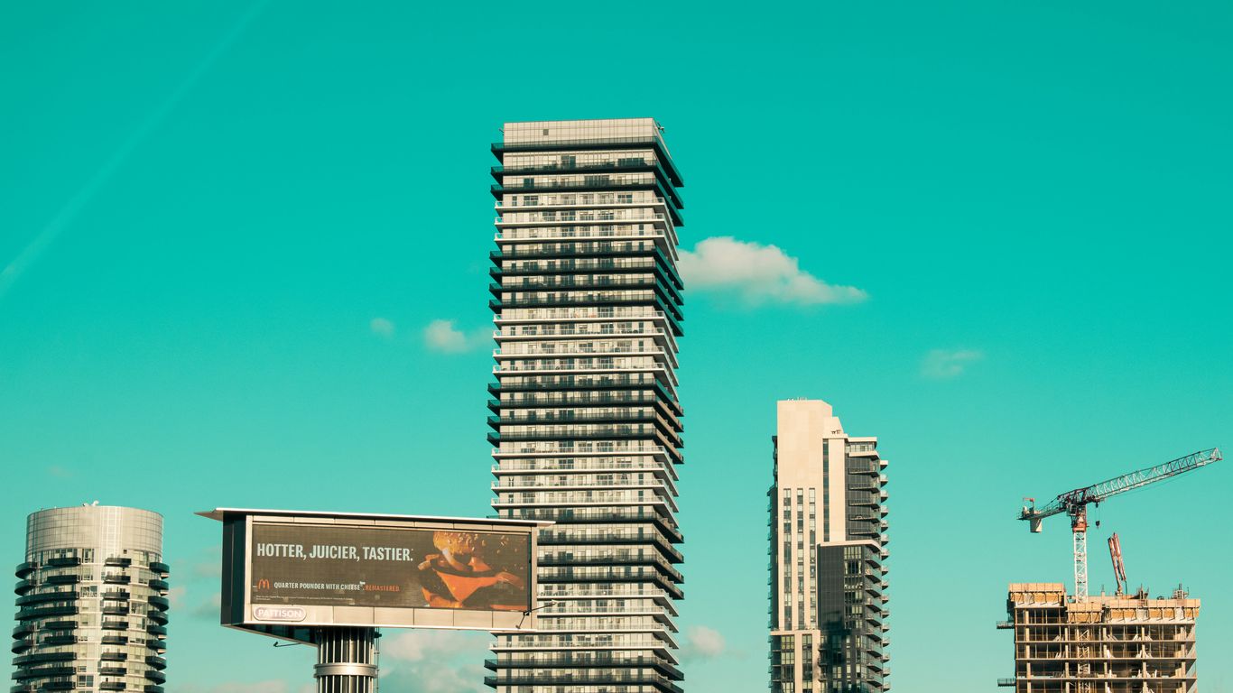 white and black high rise buildings under blue sky during daytime