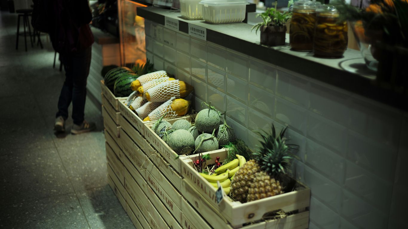 fruits in crates beside wall