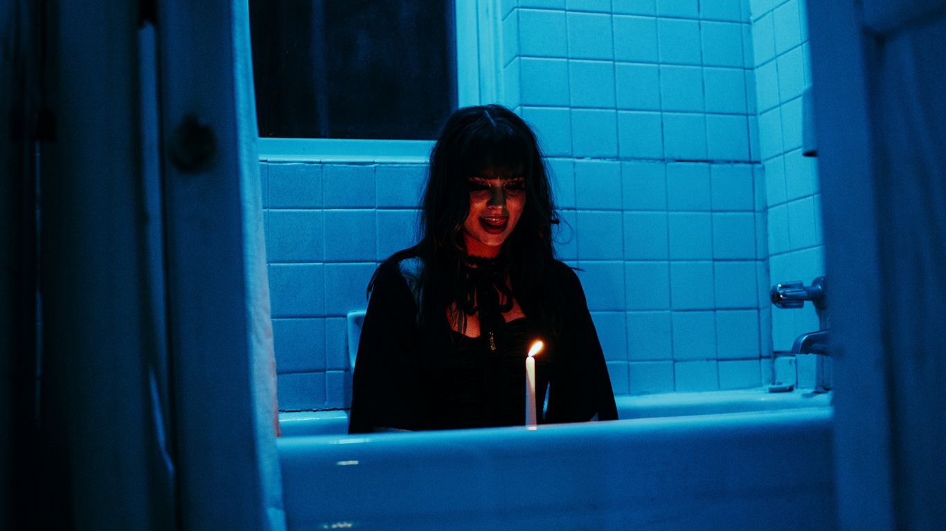 a woman sitting in a bathtub with a lit candle