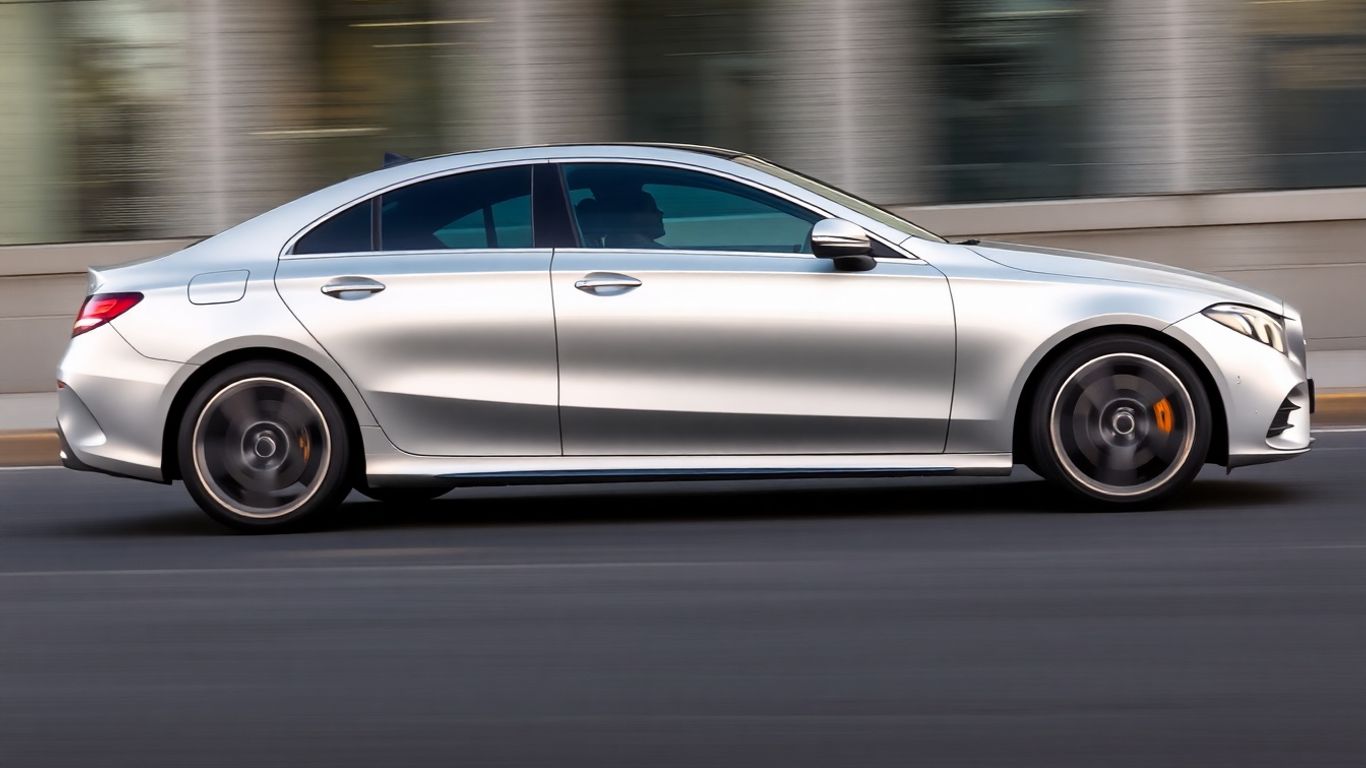 Mercedes-Benz CLA electric sedan driving on a road.