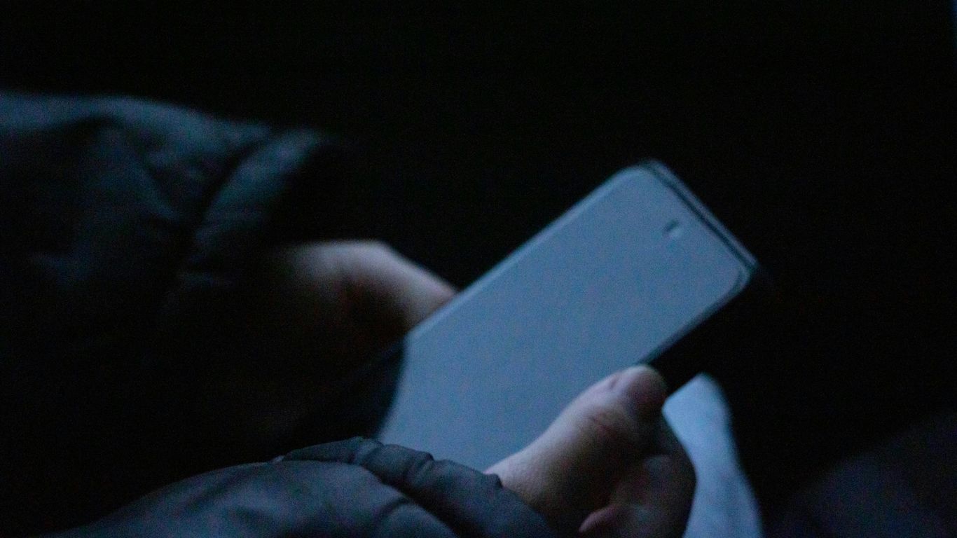 A person holding a cell phone in their hand