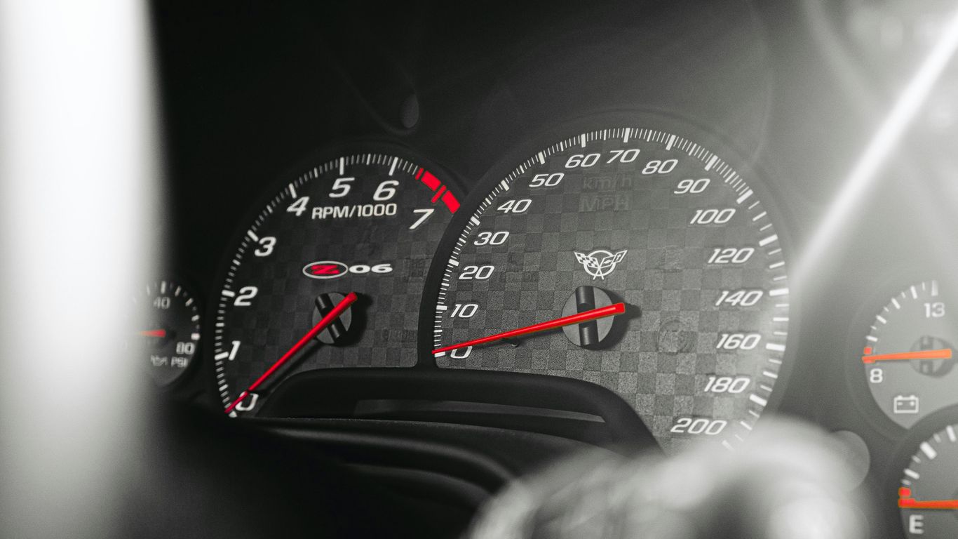 a close up of a speedometer and gauges in a car