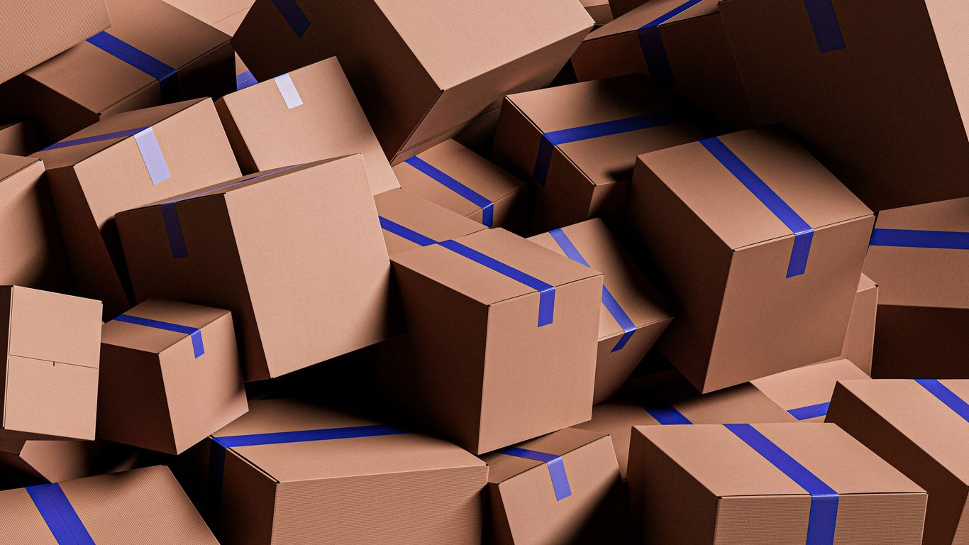 A large pile of brown cardboard boxes with blue tape.
