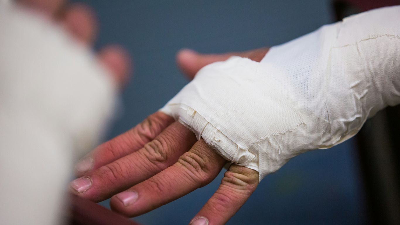 person with white bandage on hand