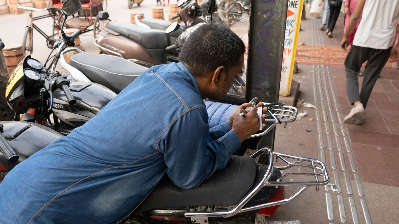 A man sitting on a motorcycle on a city street
