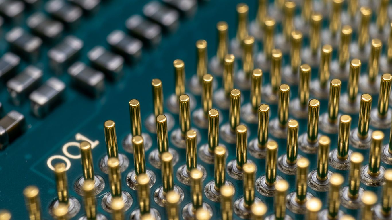 a close up of a computer board with many screws