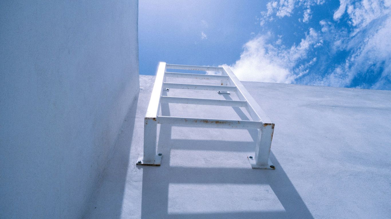 white wooden bench on white sand during daytime