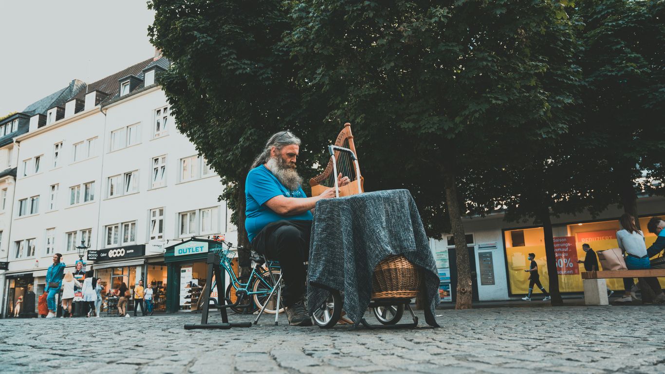 man and woman sitting on chair near green trees during daytime