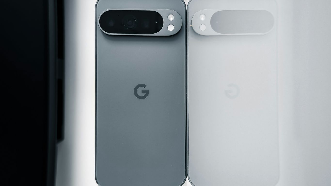 Two cell phones sitting next to each other