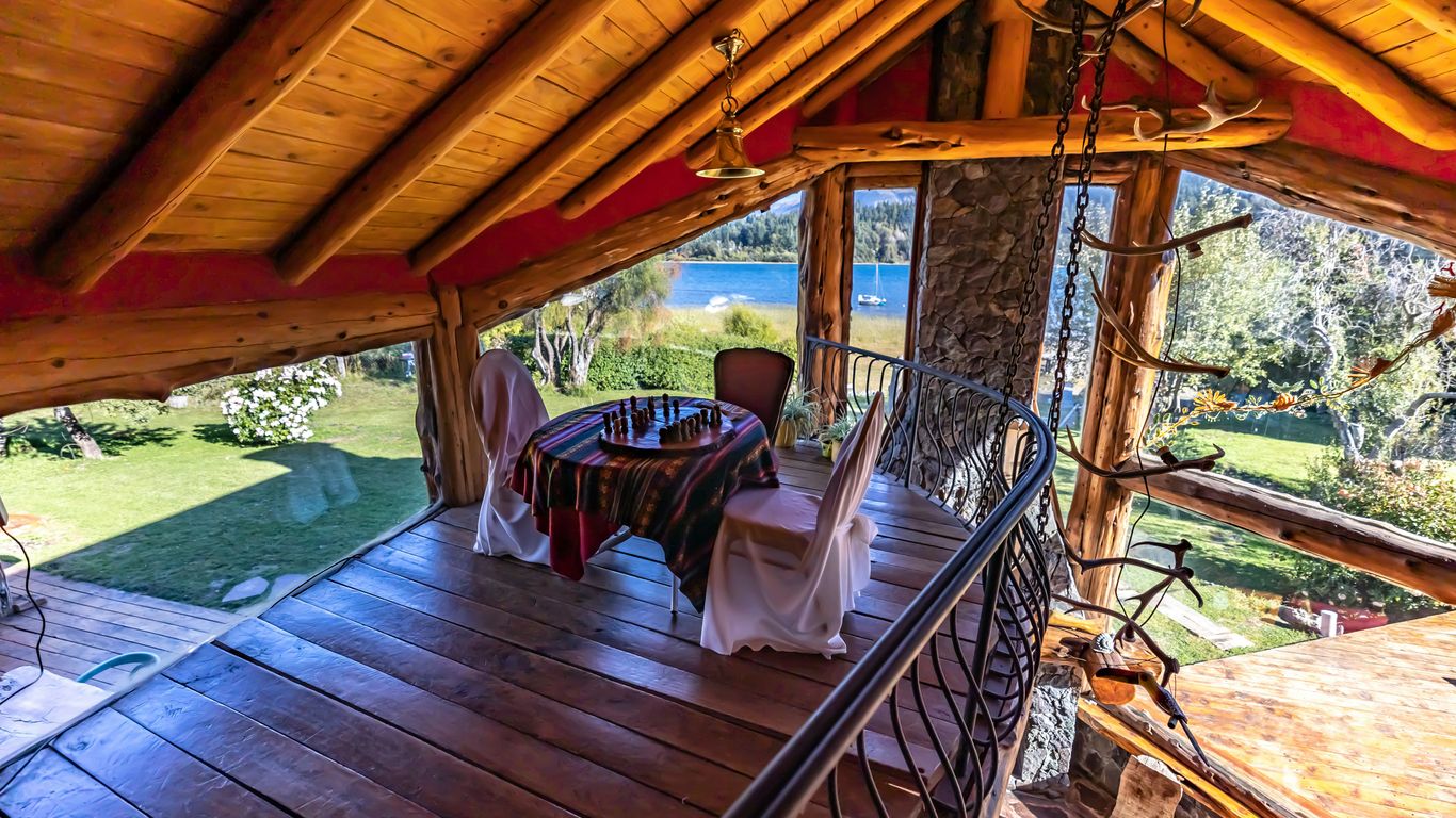 a wooden deck with a table and chairs on it