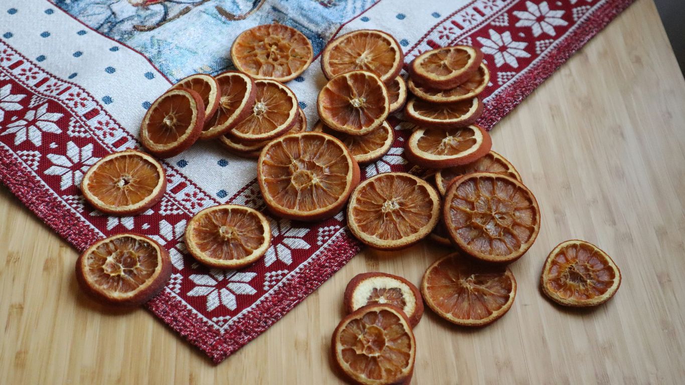 a pile of sliced oranges sitting on top of a wooden table