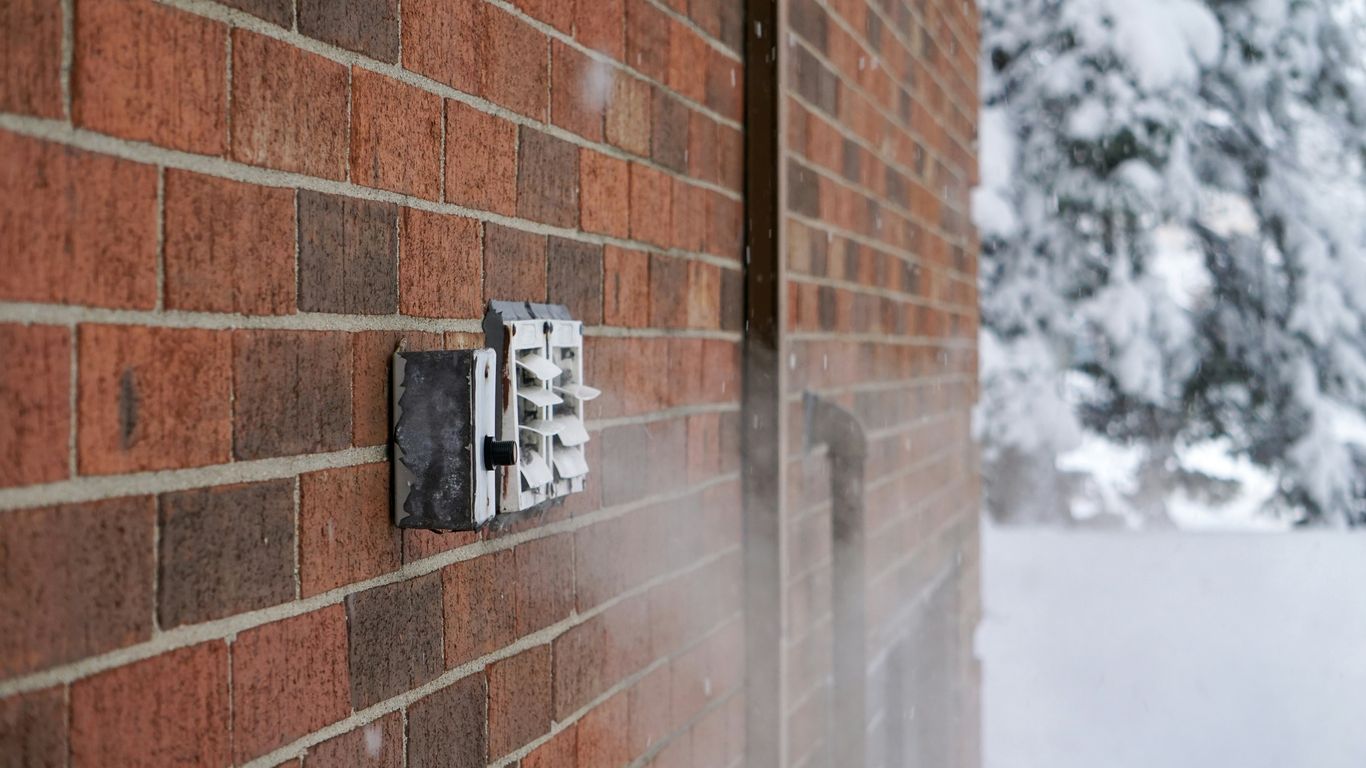 a brick wall with a light switch on it