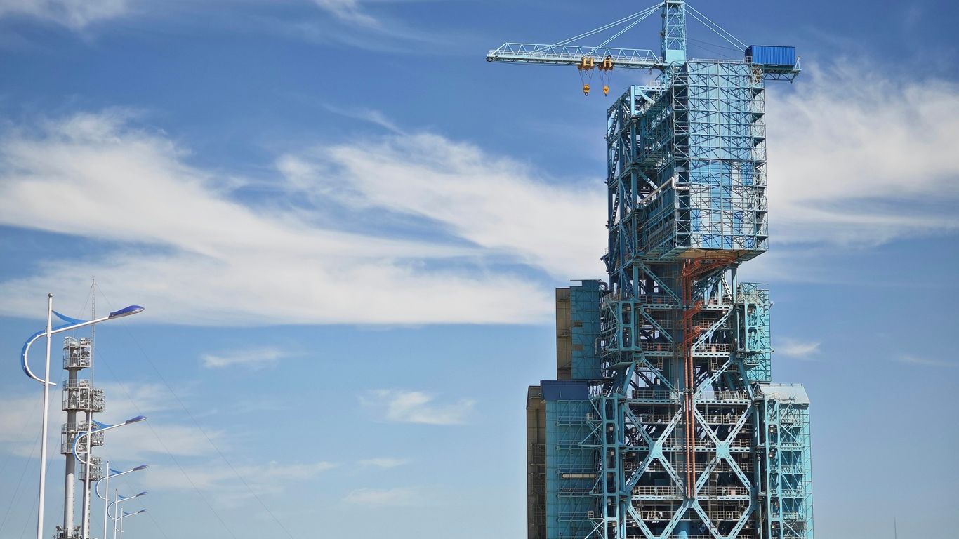 a tall building with a crane on top of it