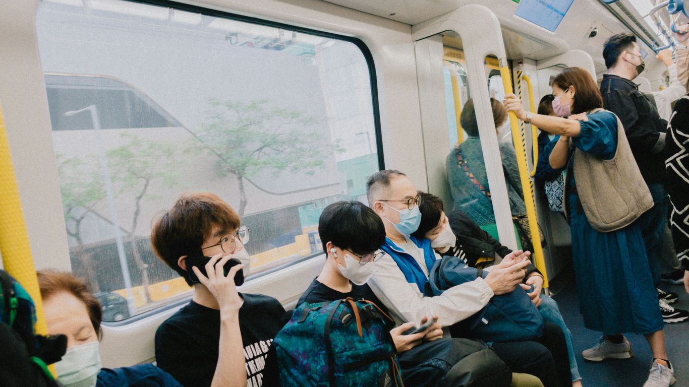 a group of people sitting on a subway train