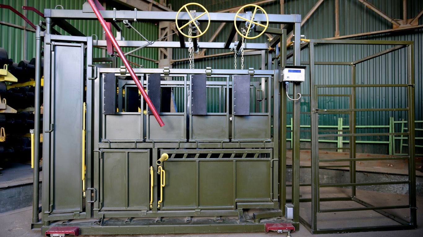 a machine in a factory with a red handle