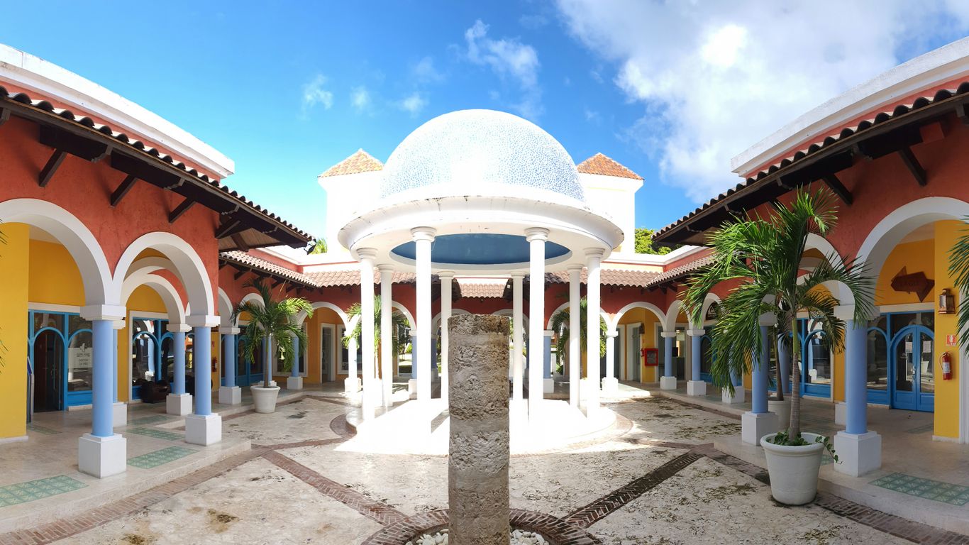 a courtyard with a fountain surrounded by palm trees