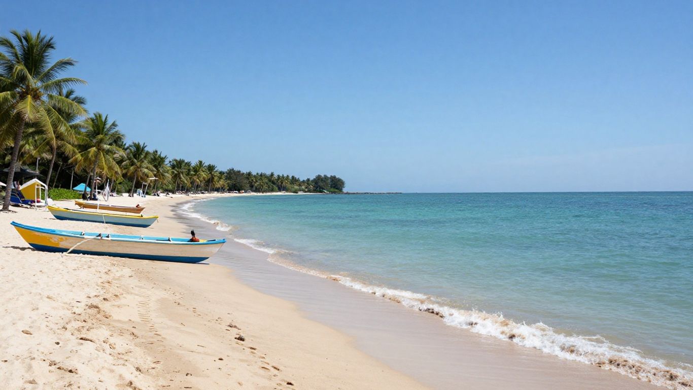 Sanur Beach with palm trees and calm turquoise waters.