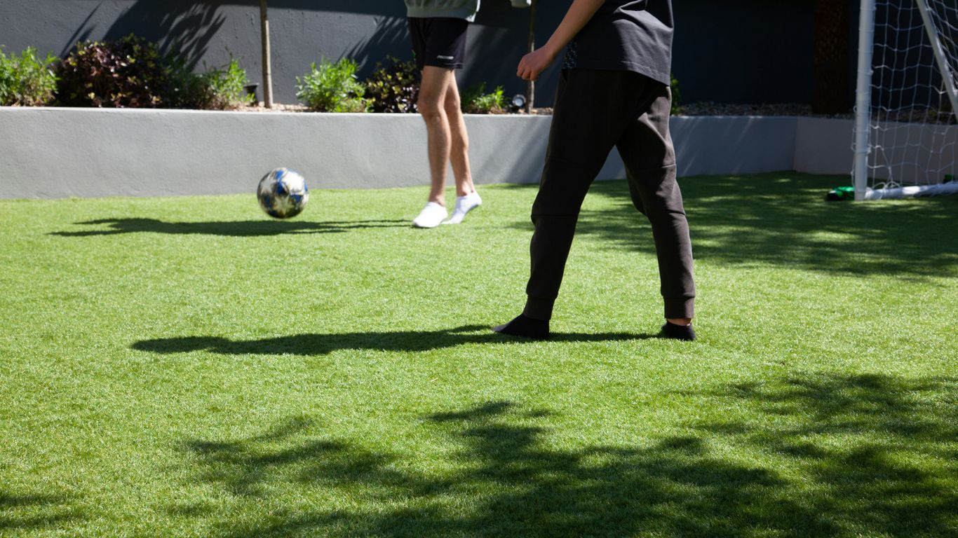 man in blue and white soccer jersey playing soccer
