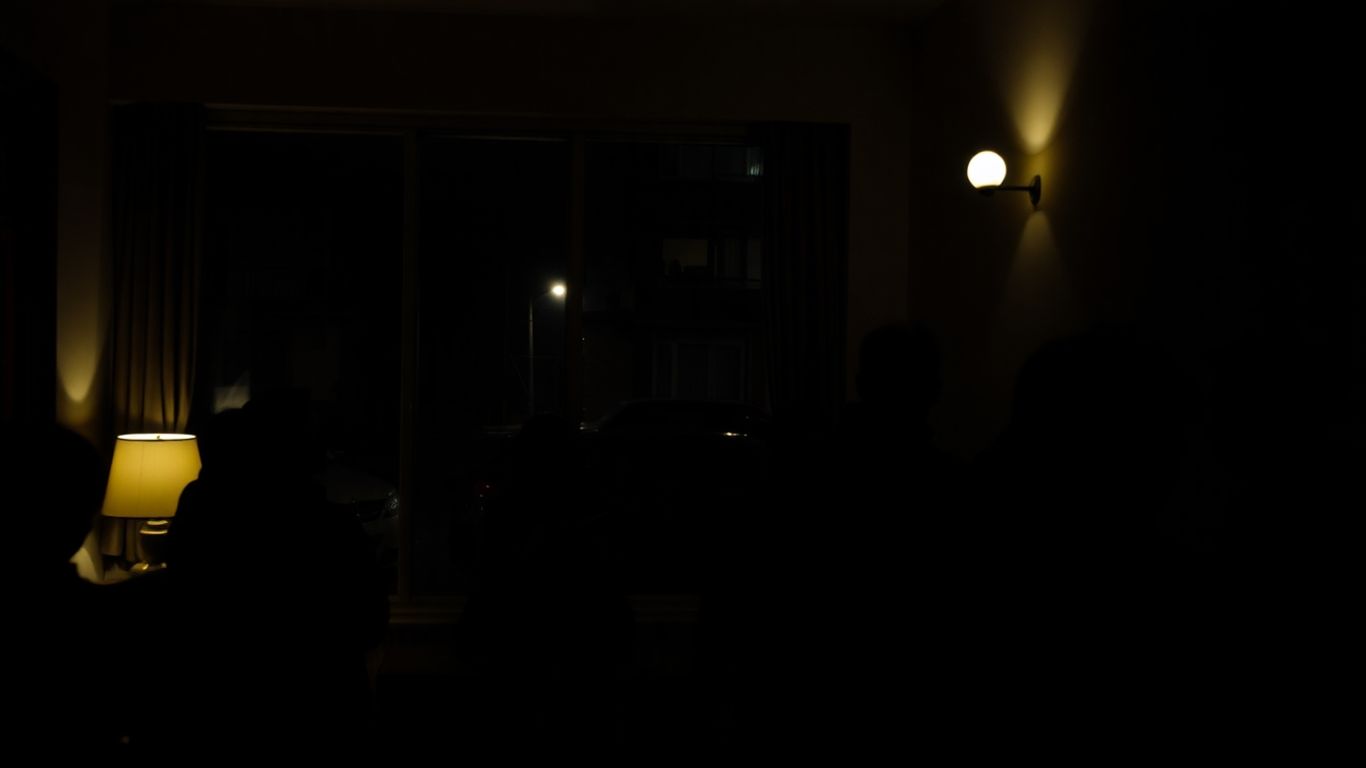 Quiet hostel common area with people relaxing.