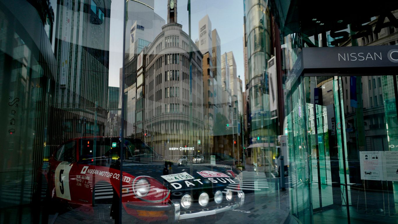 red and black porsche 911 on road near high rise buildings during night time