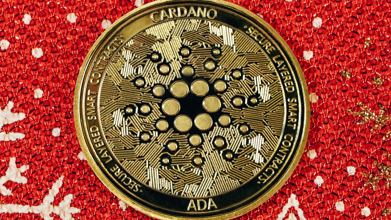 a close up of a gold medallion on a red background