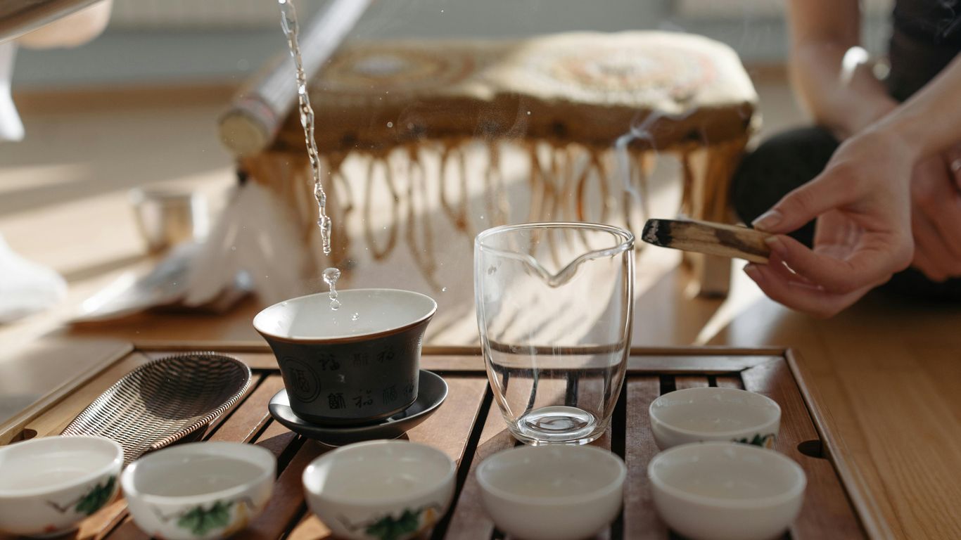 Water pouring into a tea cup during a tea ceremony.