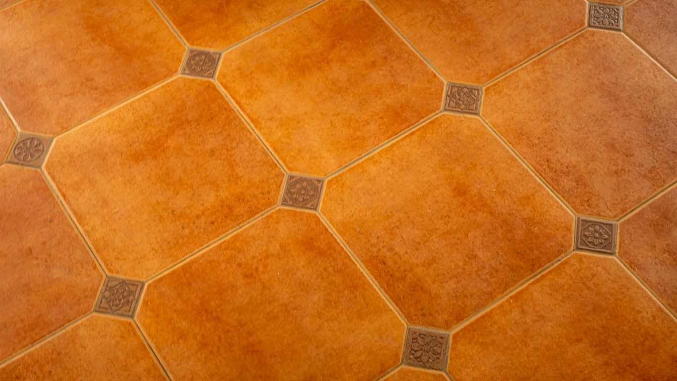Diamond-patterned tiles cover a brown surface.