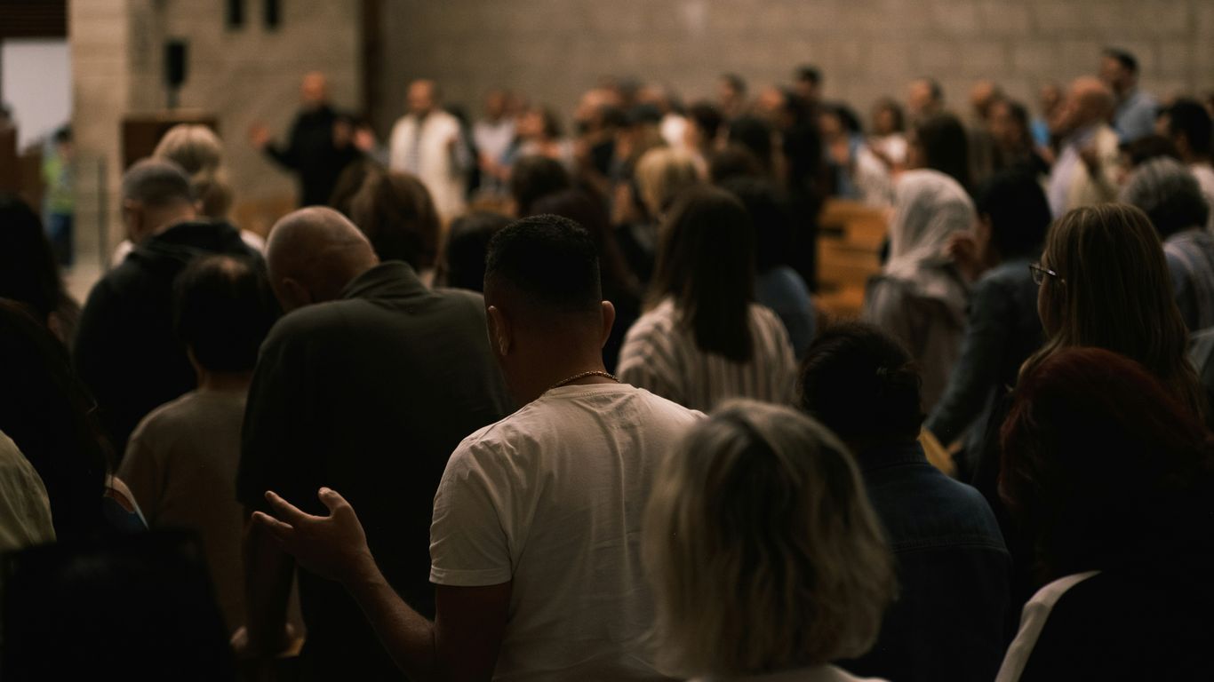 A congregation gathered inside a large hall.