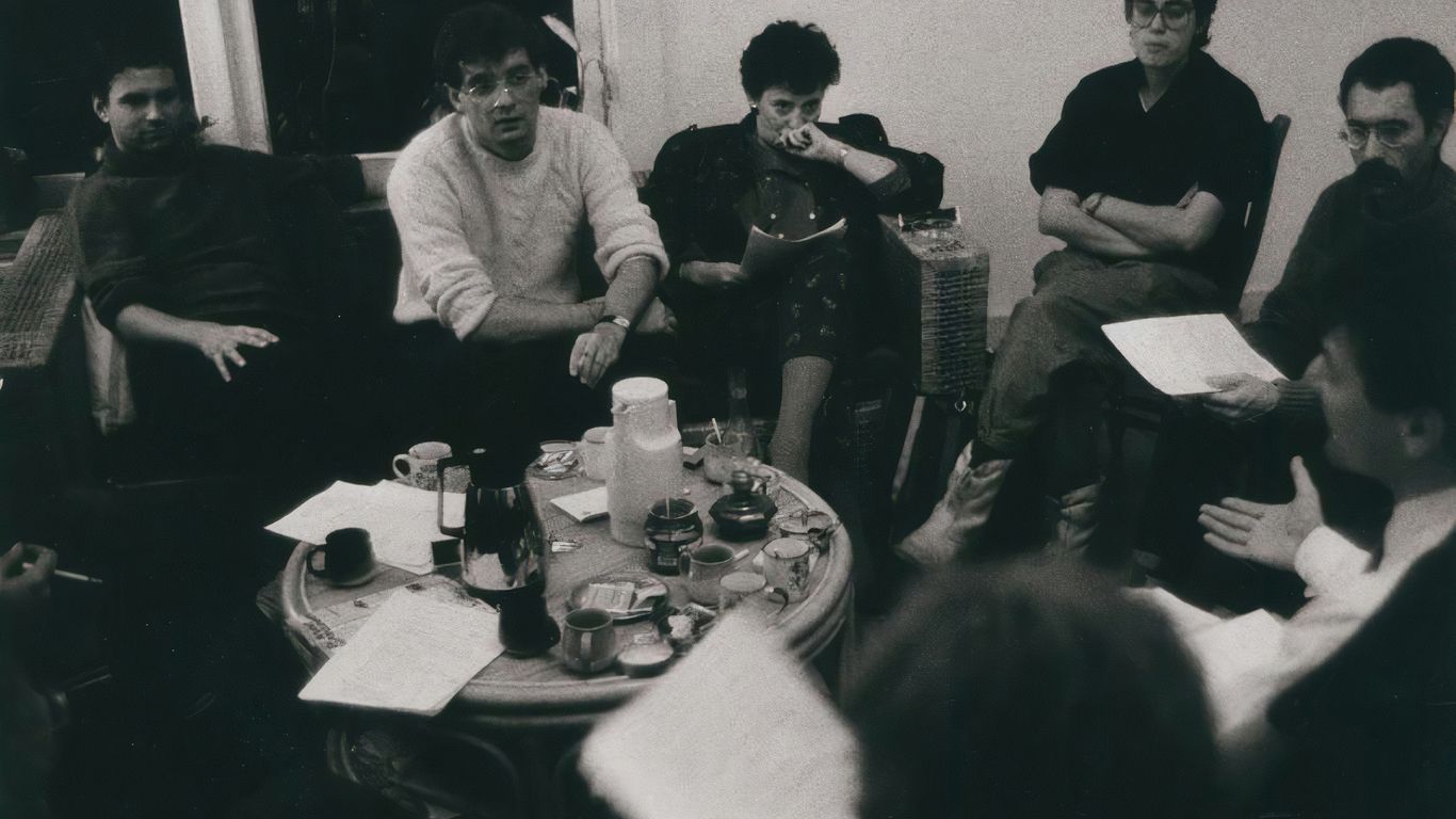a group of people sitting around a table
