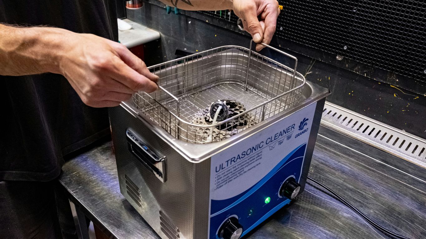 a man in a black shirt is using a machine