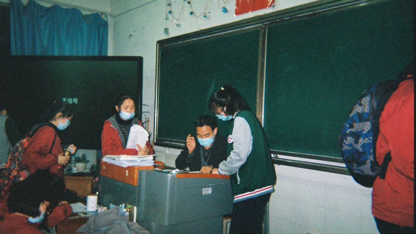 man in black and white jacket sitting beside woman in black and white jacket