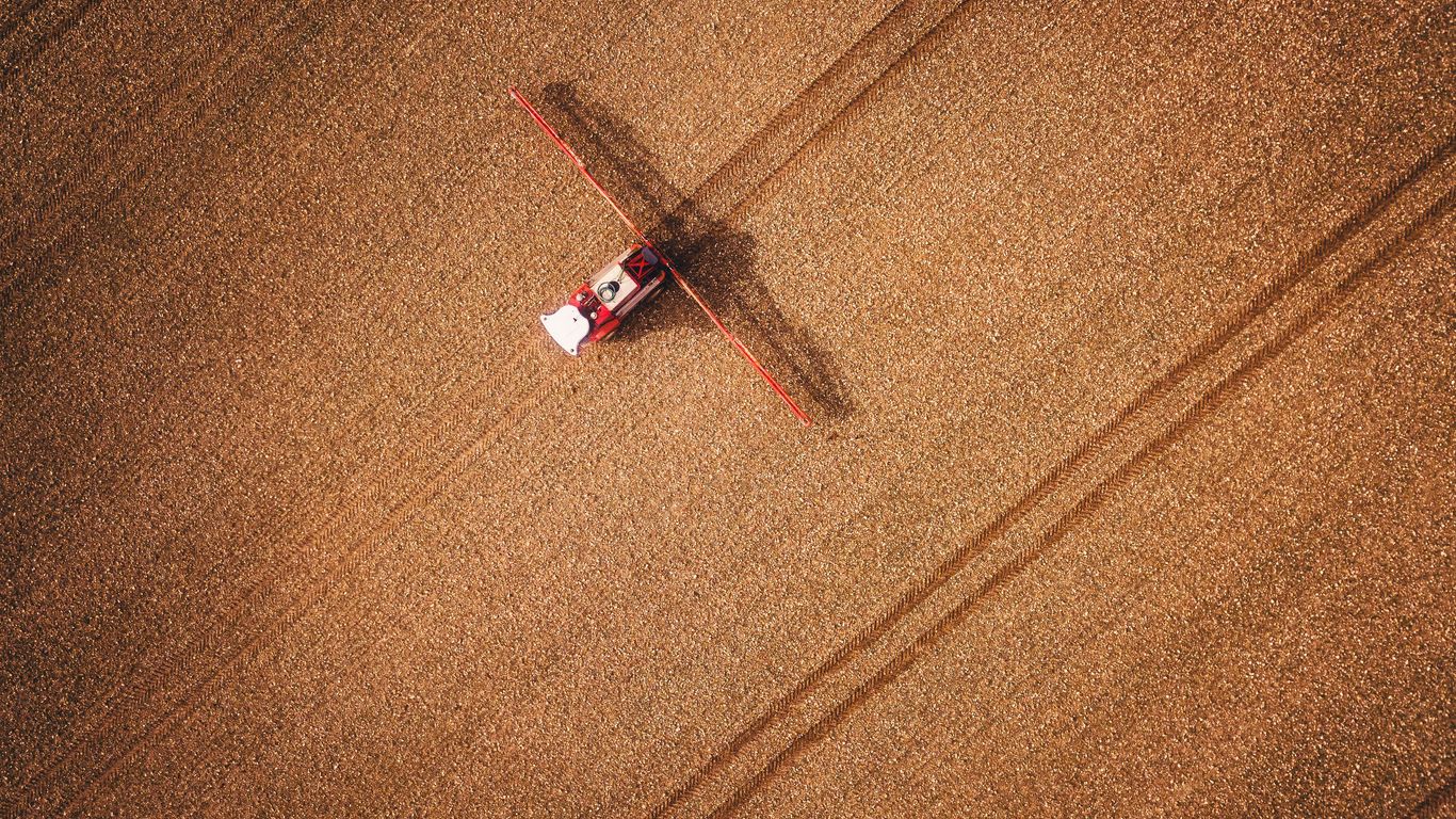 an aerial view of a red truck in a field