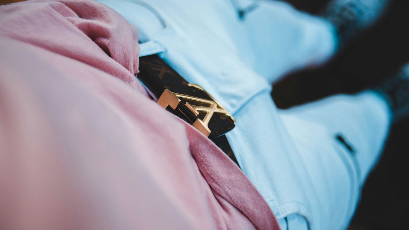 focus photography of black Louis Vuitton belt