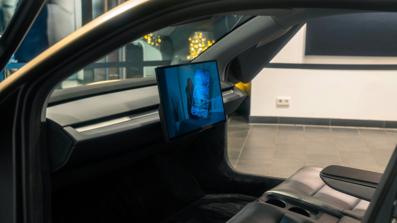 A picture of a man's face on a monitor in a car