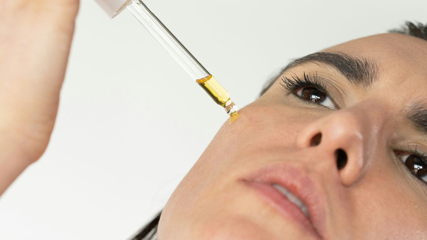 a woman getting her eyebrows done with a syring