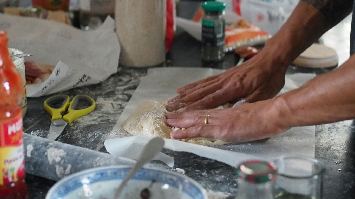 a person is kneading dough on a counter