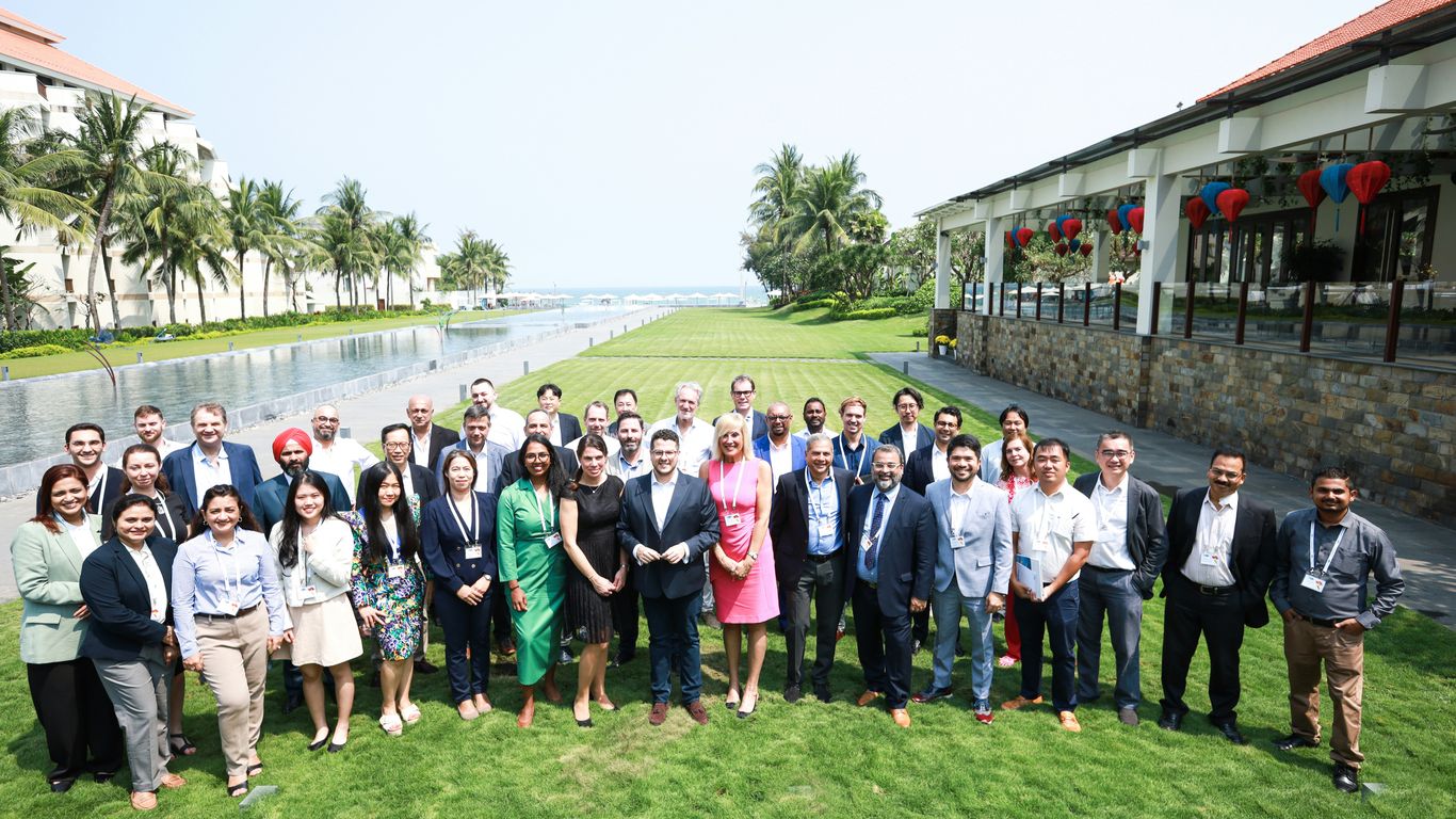 A diverse group of people posing for a photo outdoors.