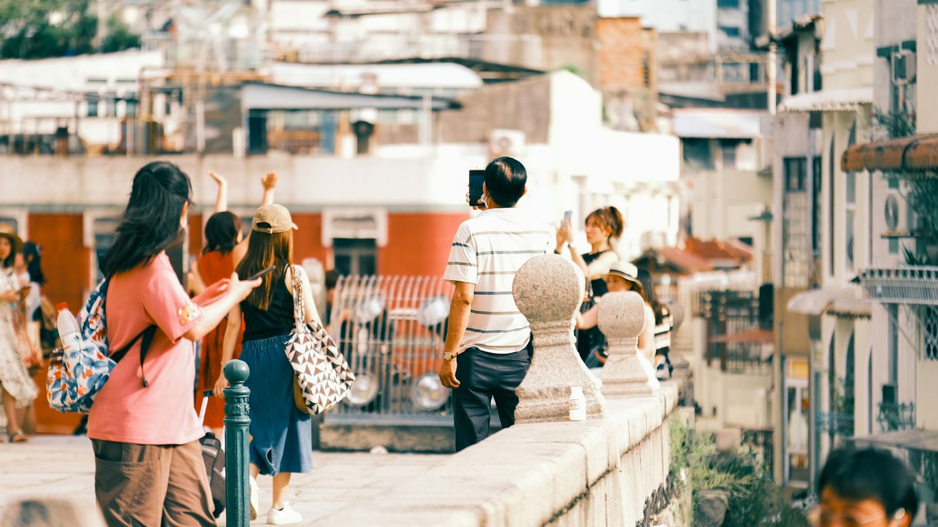 A group of people walking across a bridge