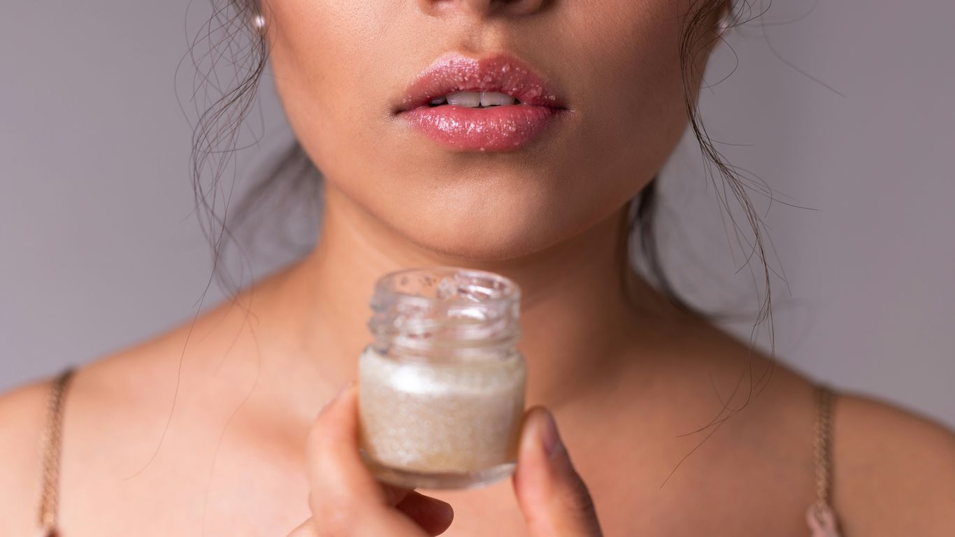 woman holding white plastic bottle