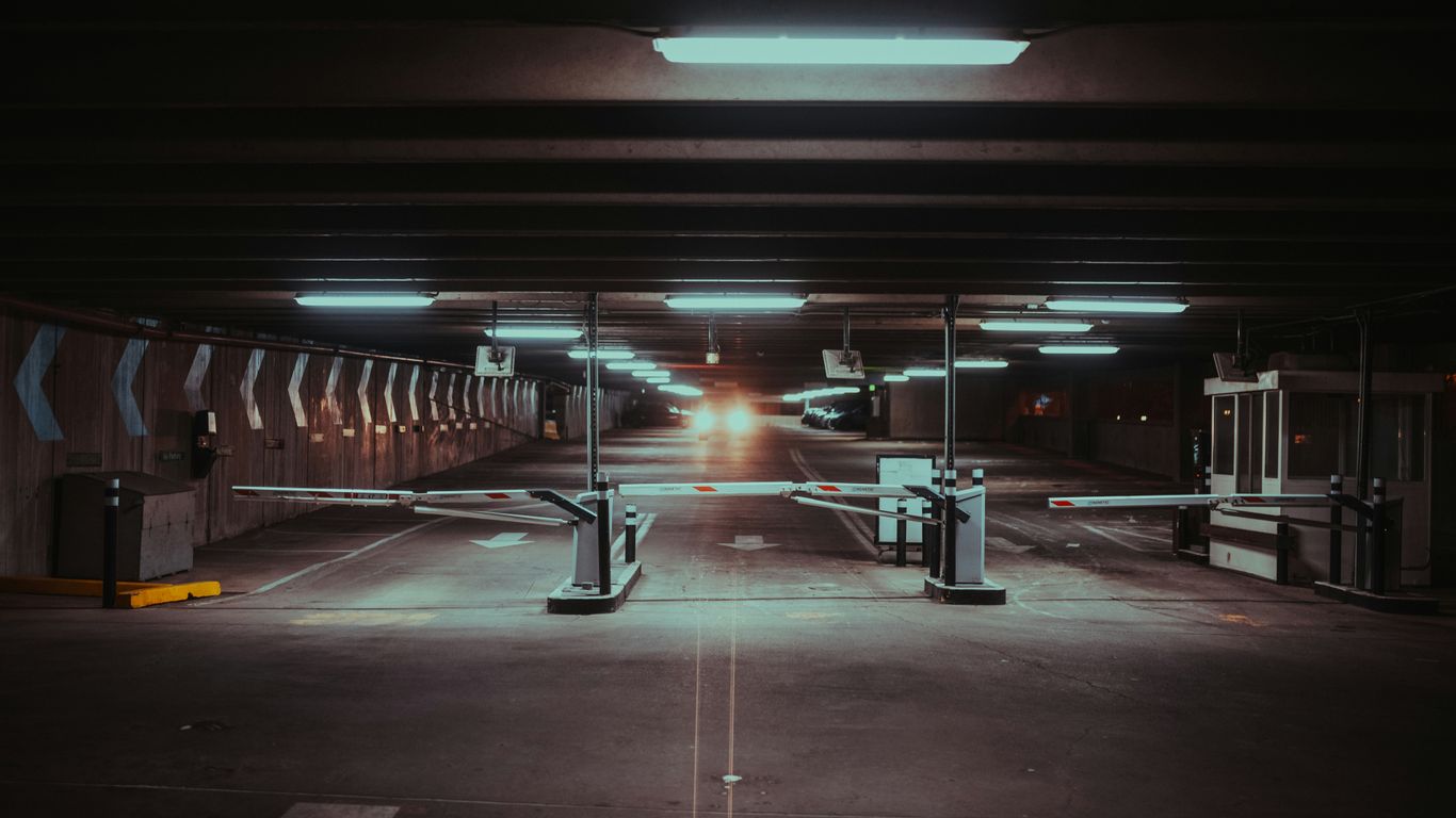 an empty parking garage with lights on the ceiling